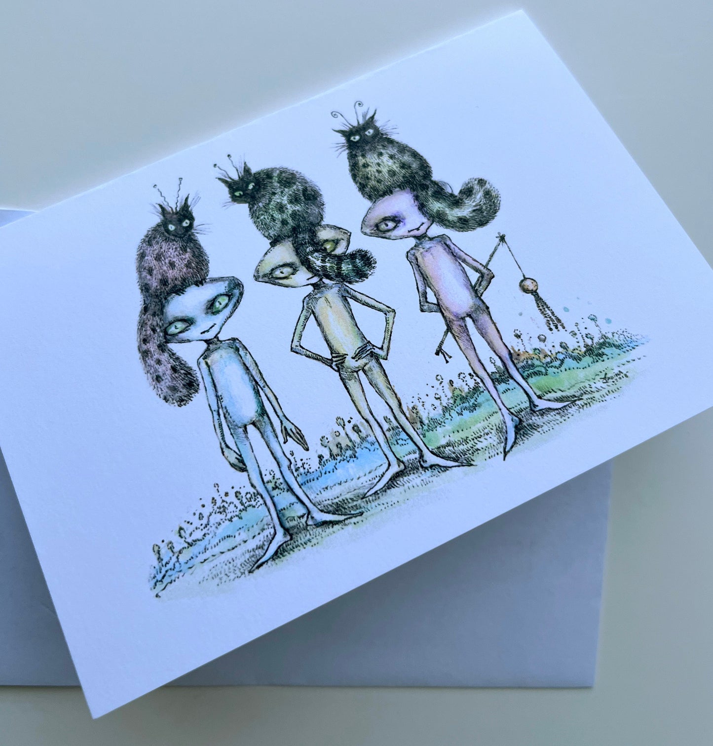 Greeting card with alien characters and their cats on a white background