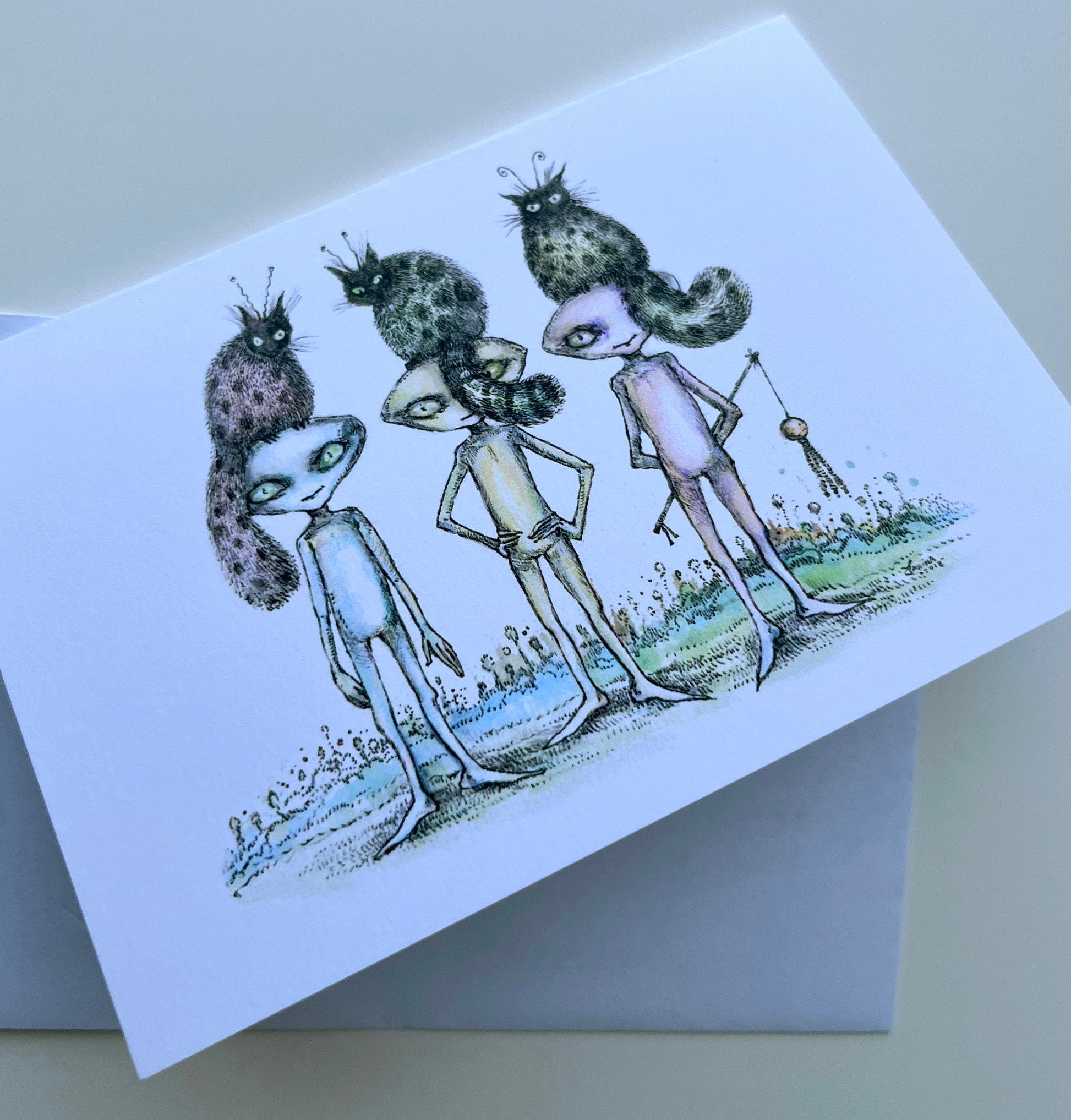 Greeting card with alien characters  and their cats on a white background